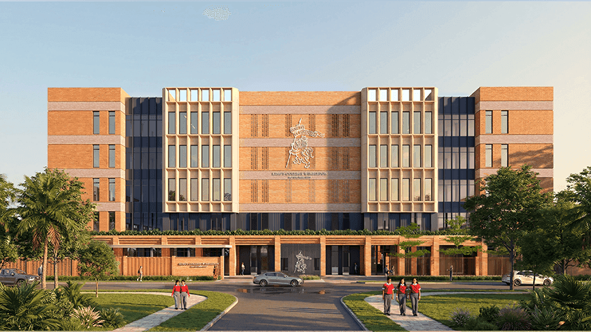 Modern university building with a grand entrance, circular driveway, and lush green landscaping.